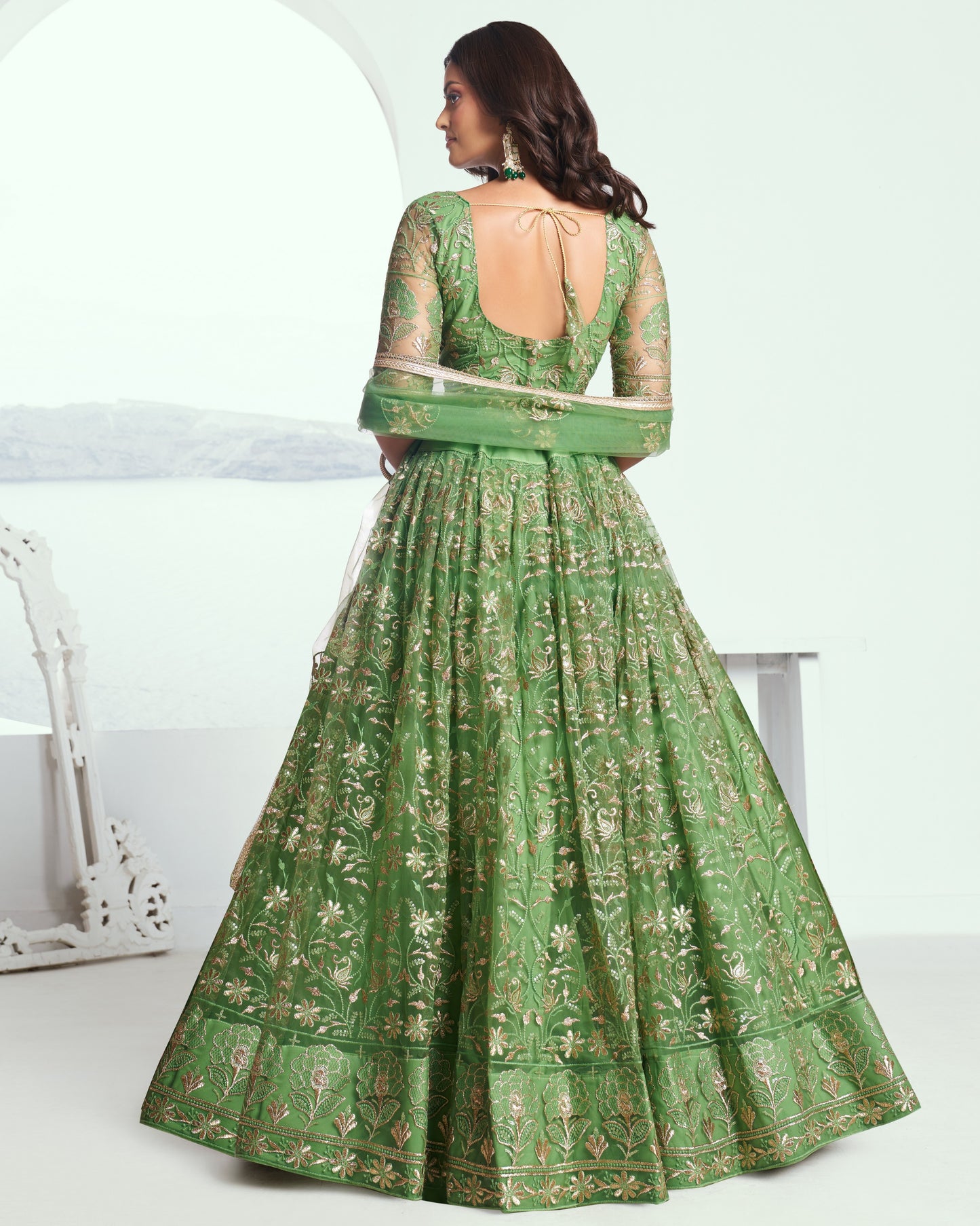 Green embroidered dress with a white background
