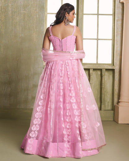 Pink evening gown with floral details on a neutral background