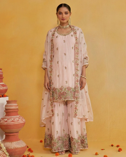 Woman wearing a floral embroidered outfit against a yellow background