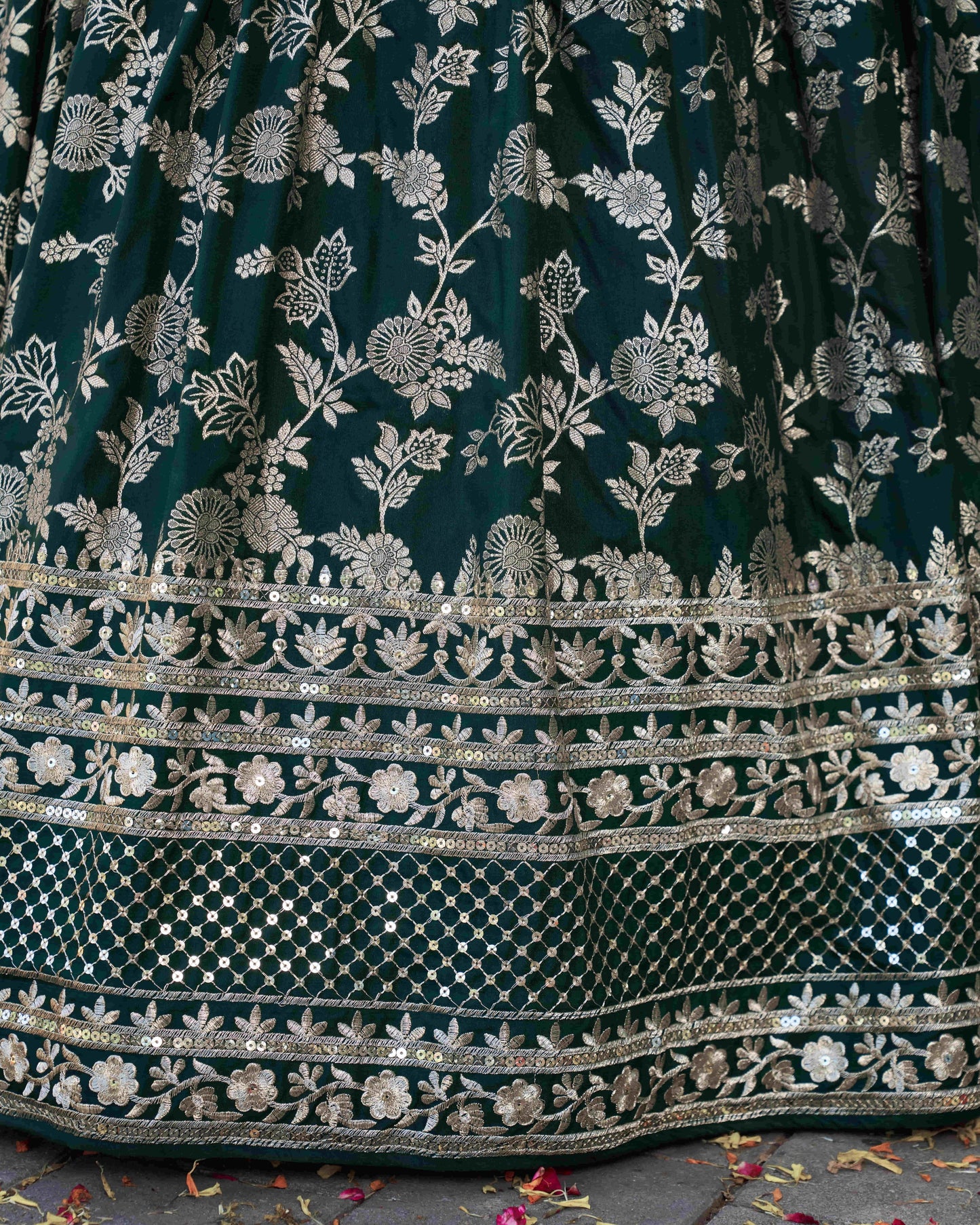 Dark green fabric with intricate silver floral embroidery