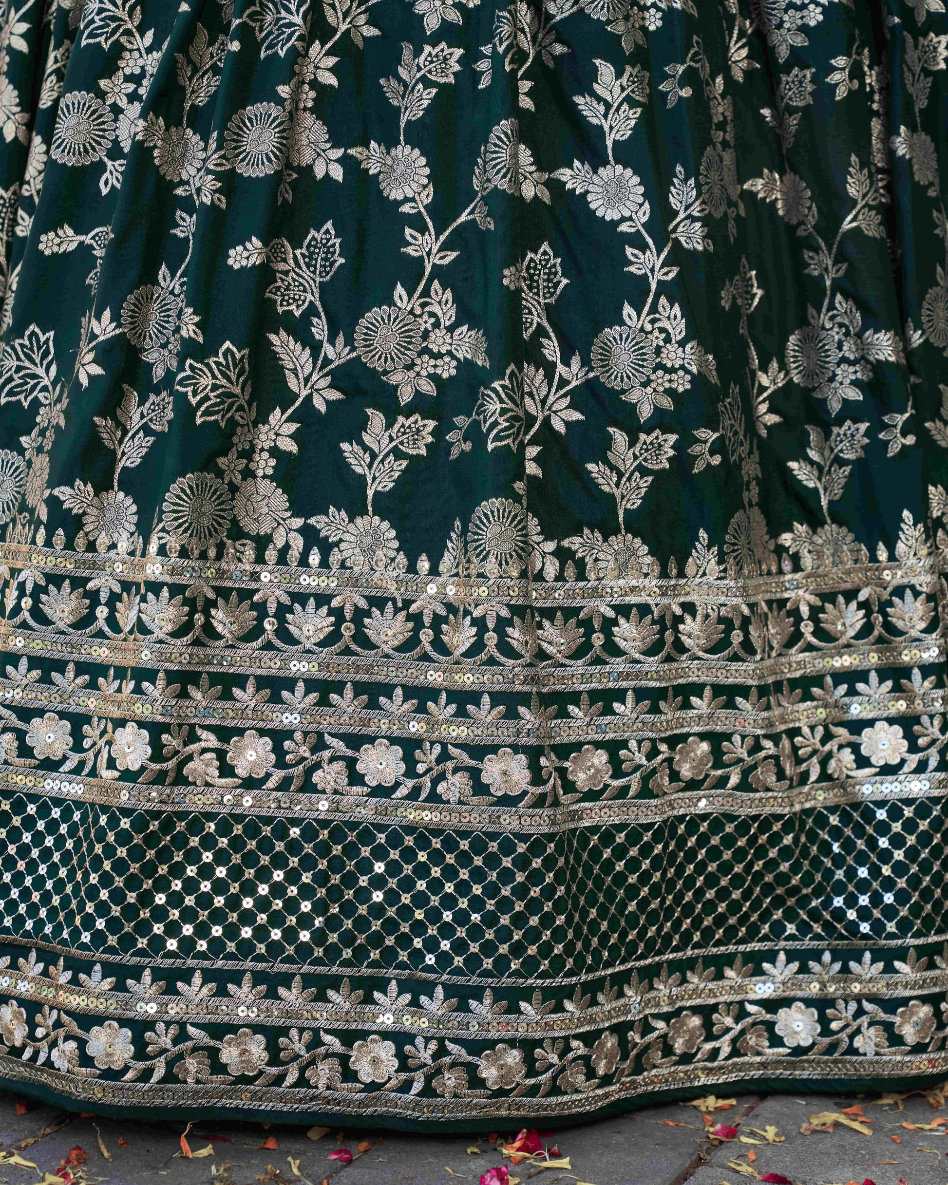 Dark green fabric with intricate silver floral embroidery