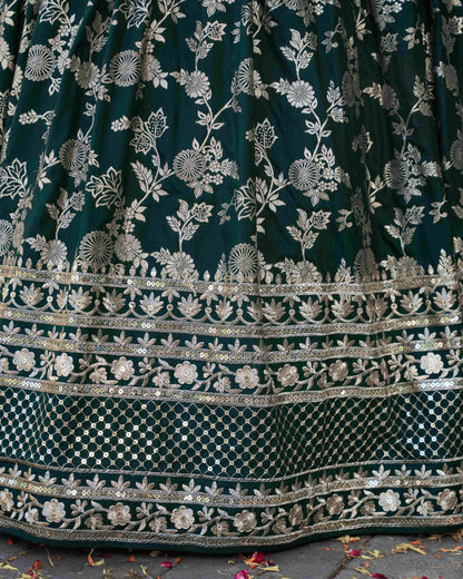 Dark green fabric with intricate silver floral embroidery