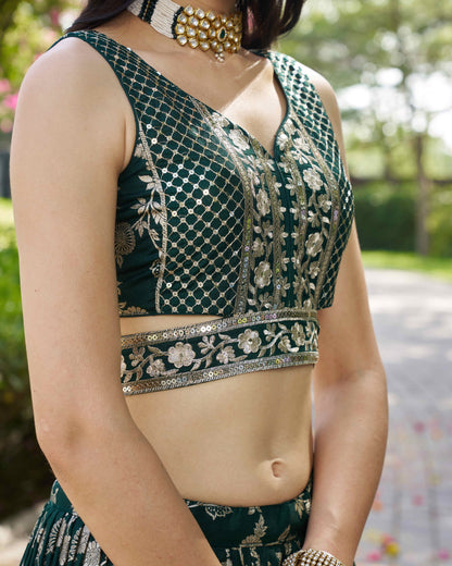Green embroidered blouse with silver details worn by a person outdoors.