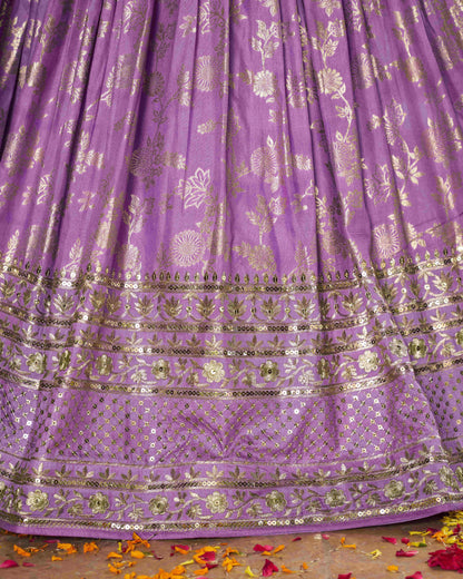 Purple fabric with gold embroidery on a wooden surface
