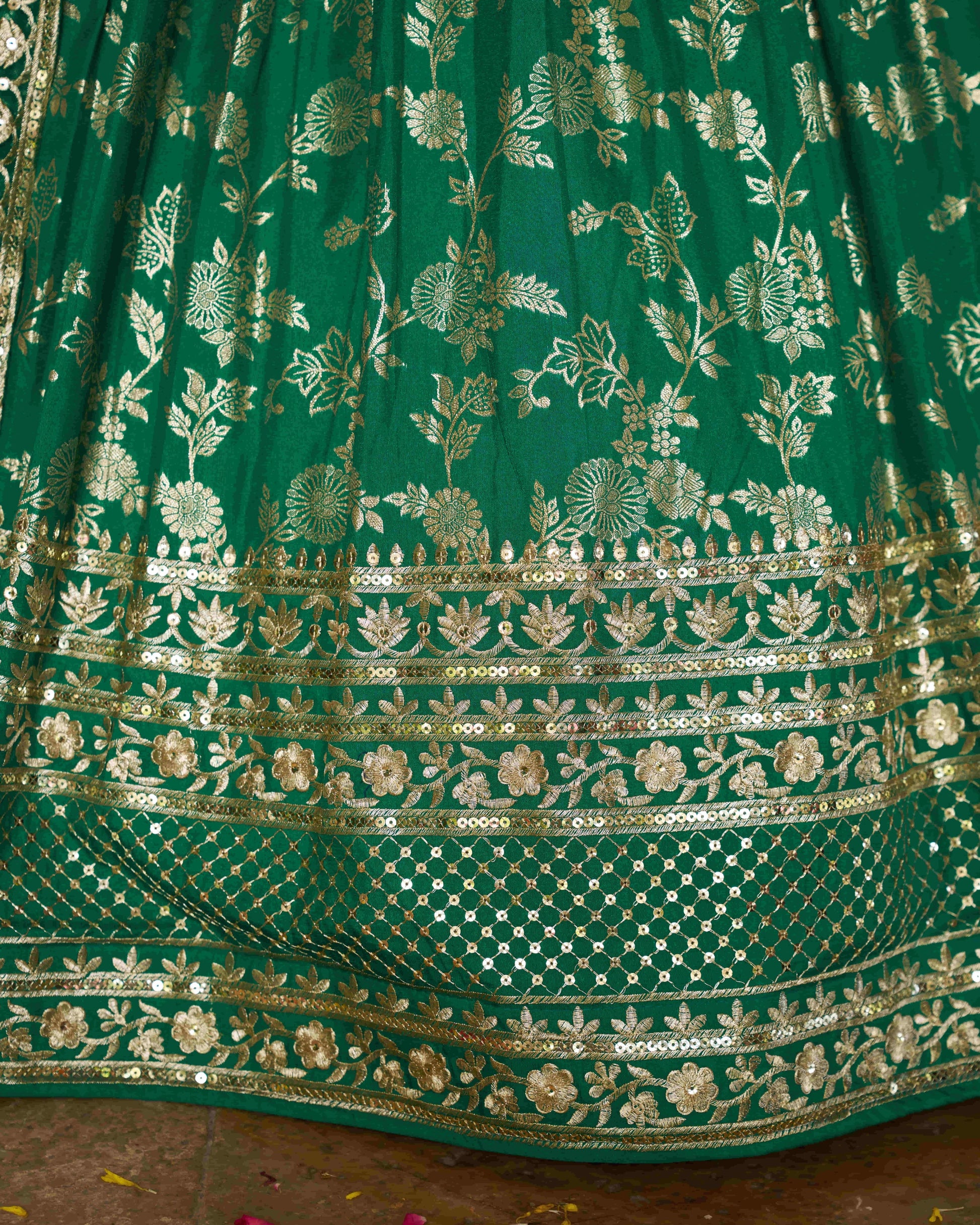 Green embroidered fabric with gold patterns