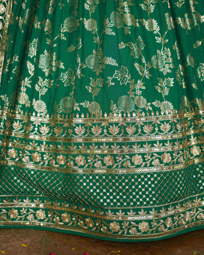 Green embroidered fabric with gold patterns