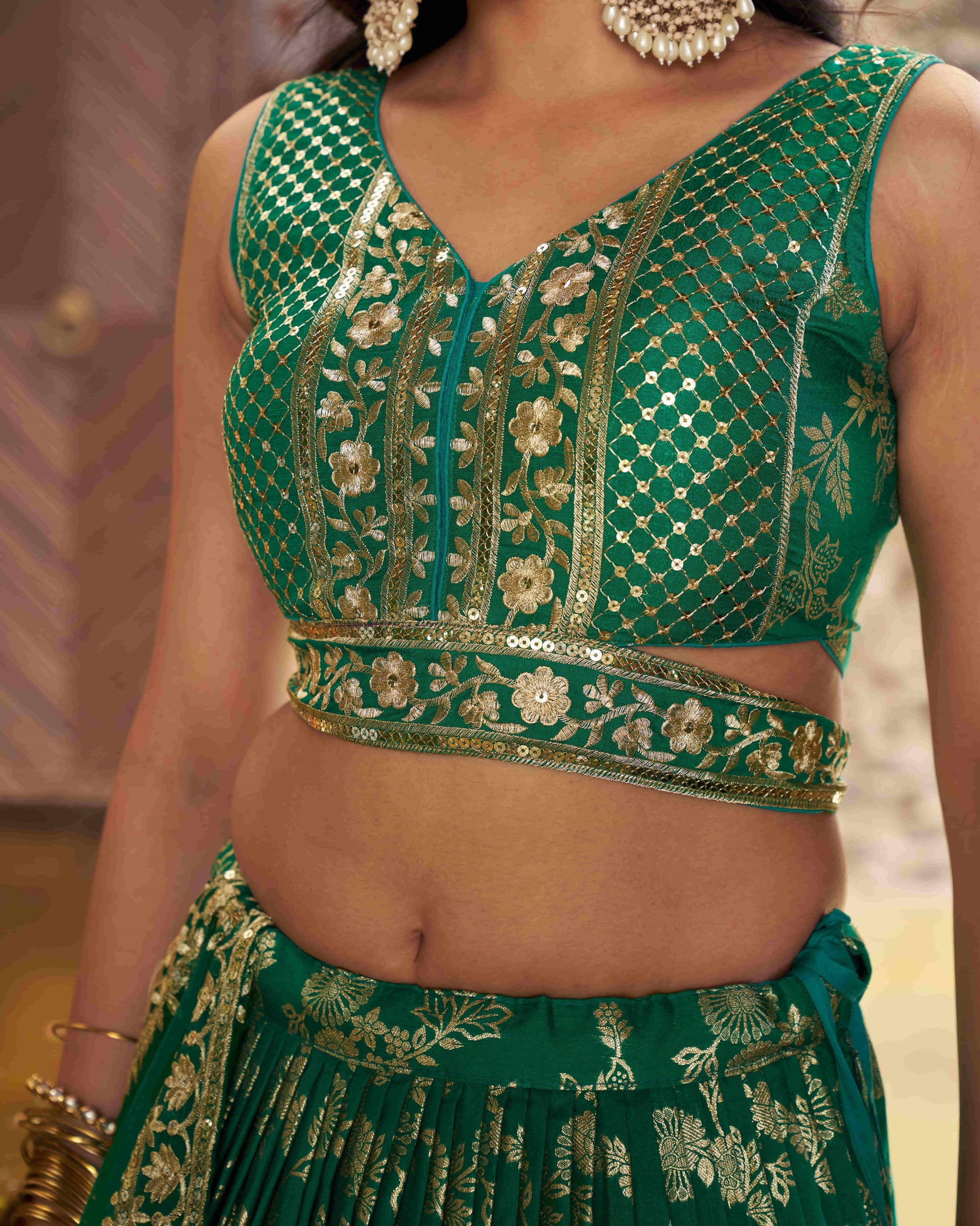 Green embroidered traditional outfit with gold details