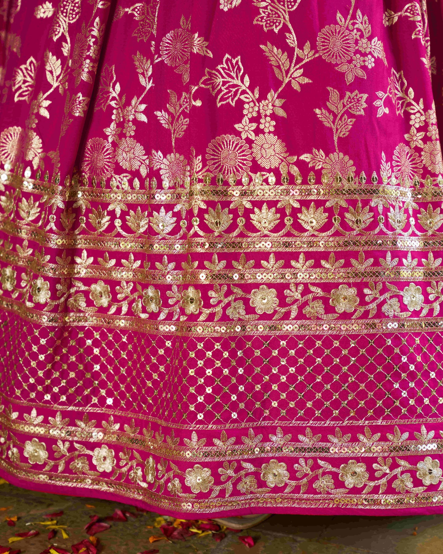 Close-up of a pink fabric with gold floral patterns
