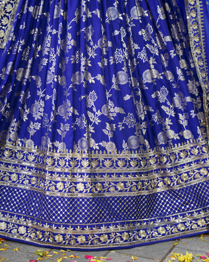Blue fabric with white floral patterns and gold accents on a stone surface.