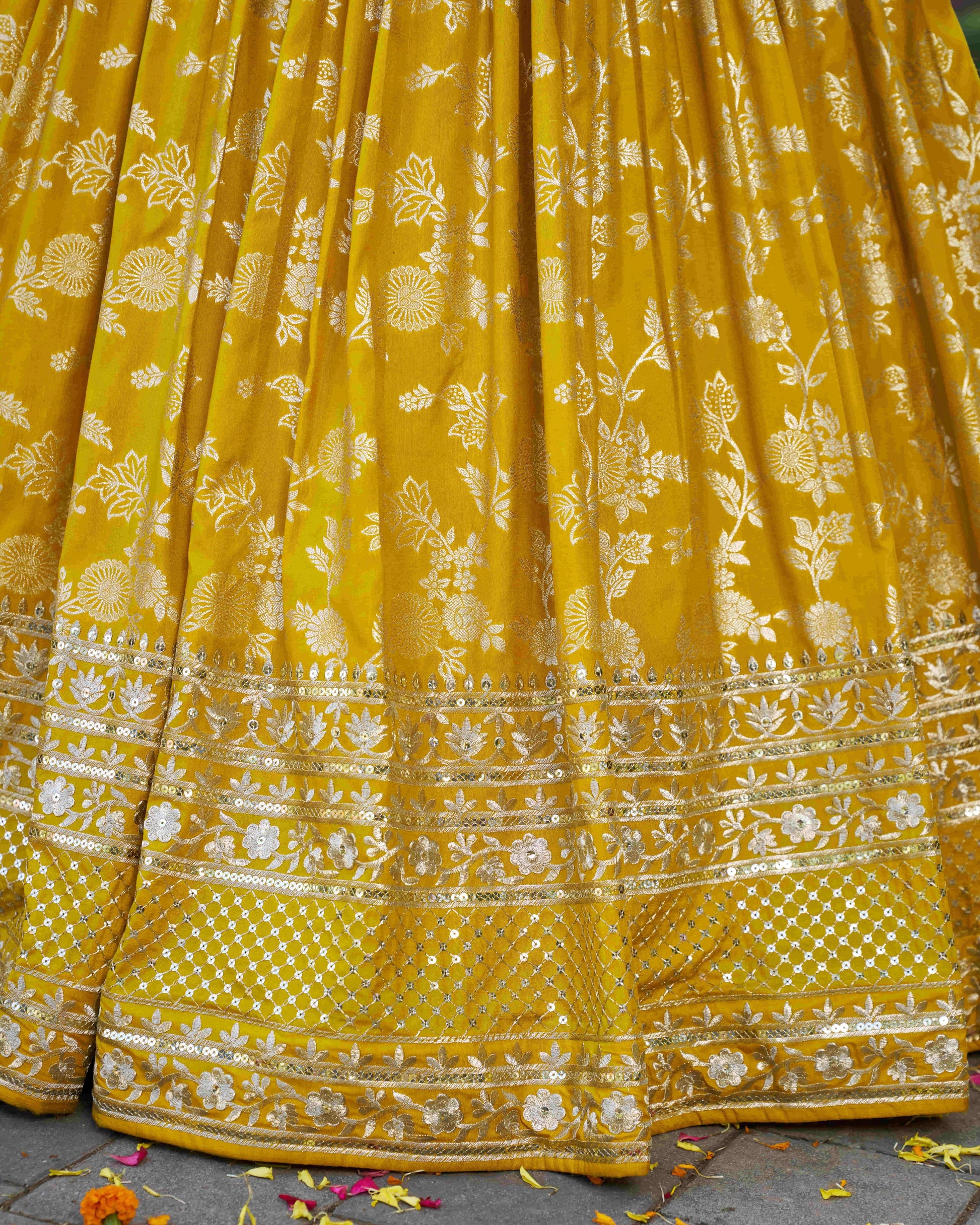 Yellow saree with floral patterns on a textured surface