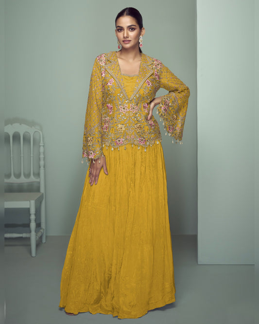 Woman wearing a yellow embroidered dress in a minimalistic setting