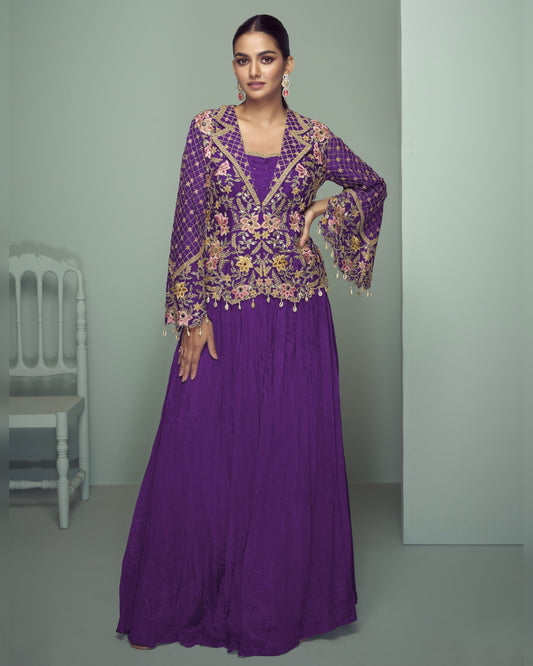 Woman wearing a purple embroidered outfit in a minimalistic setting