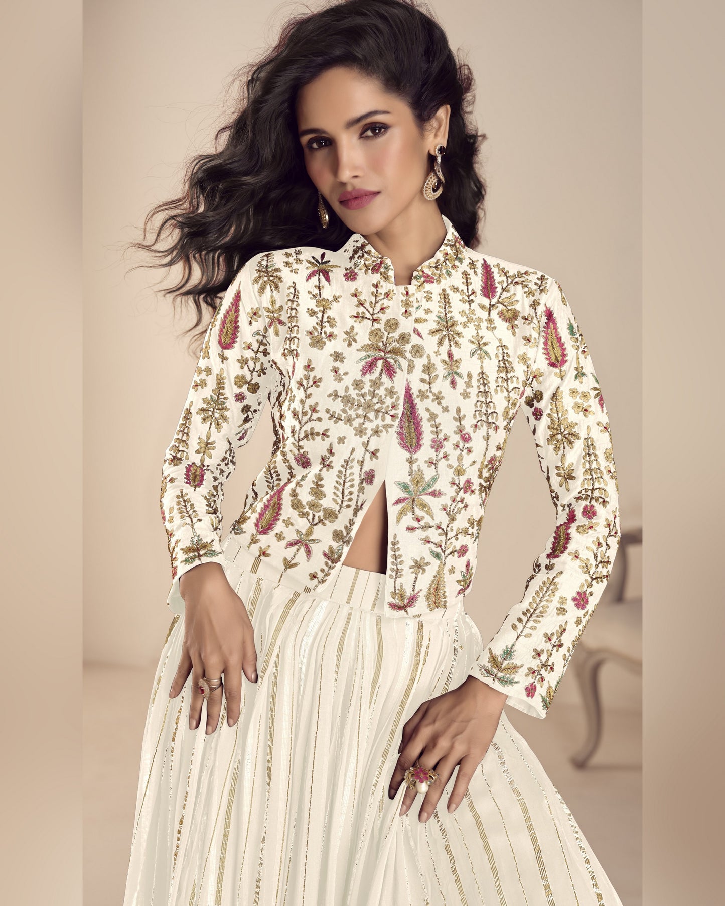 Woman wearing a floral blouse and white skirt against a neutral background