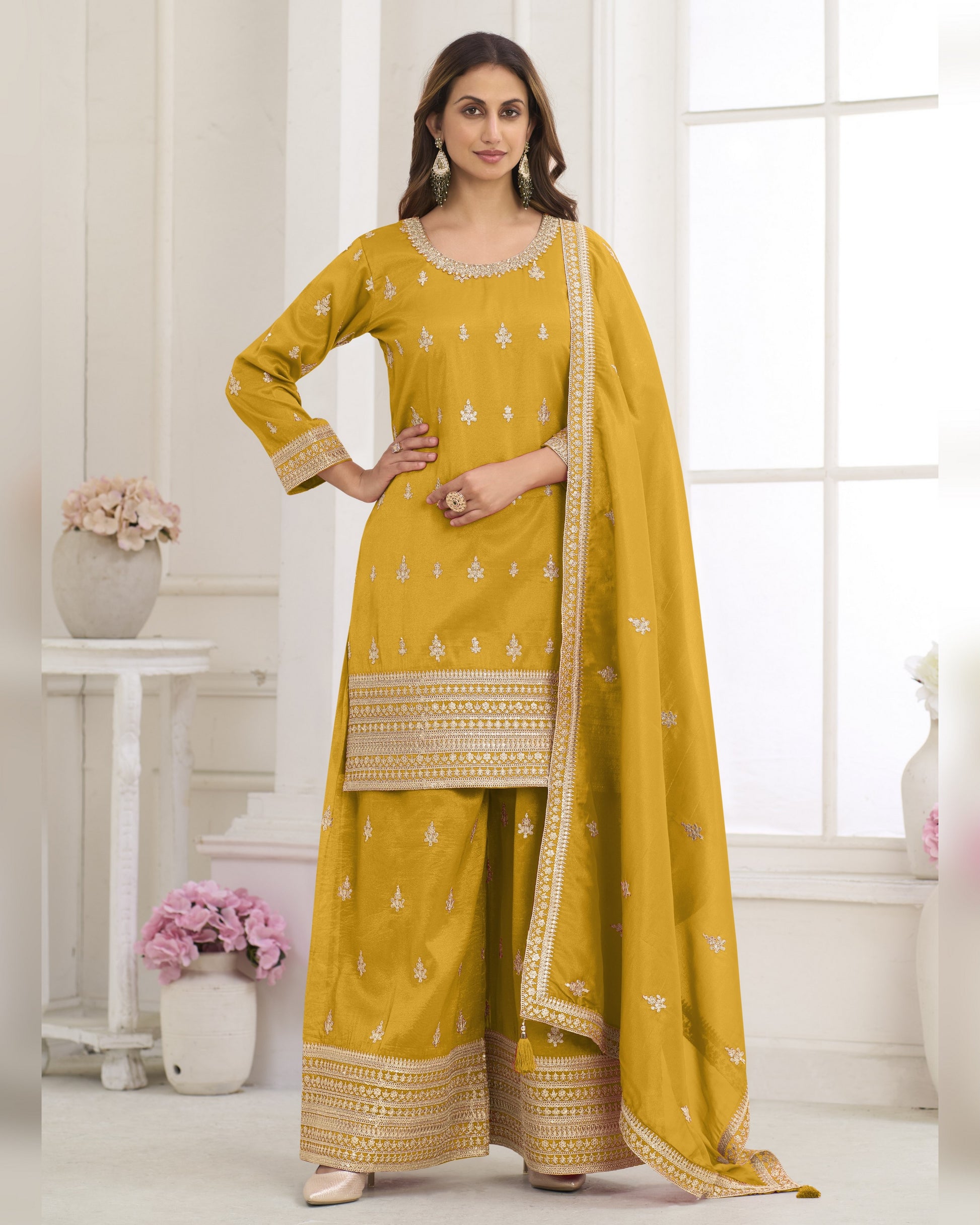 Woman wearing a yellow traditional outfit with a white background