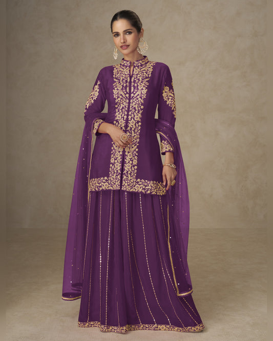Woman wearing a purple traditional outfit with gold embroidery on a beige background