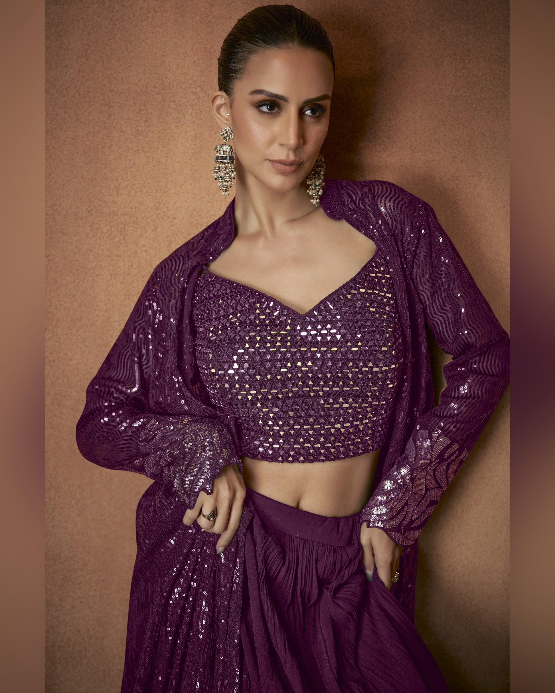 Woman wearing a purple sequined outfit against a brown background