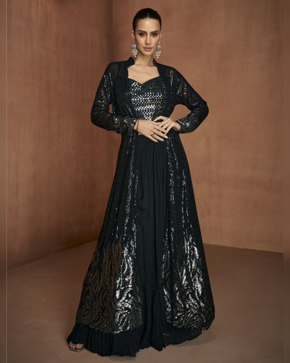 Woman wearing a black sequin dress against a brown background