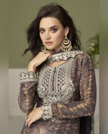 Woman wearing an ornate traditional outfit with intricate patterns and jewelry.
