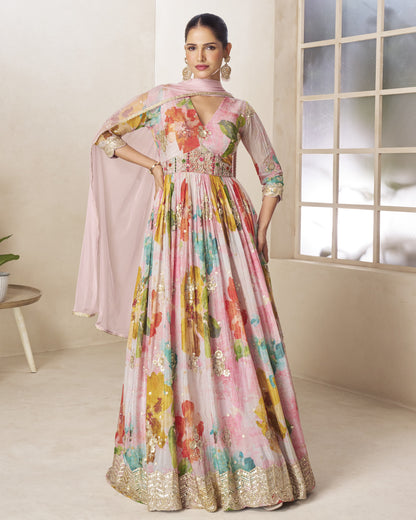 Woman wearing a colorful floral dress in a room with a window.