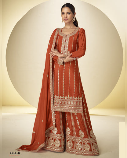 Woman wearing an orange embroidered traditional outfit on a beige background