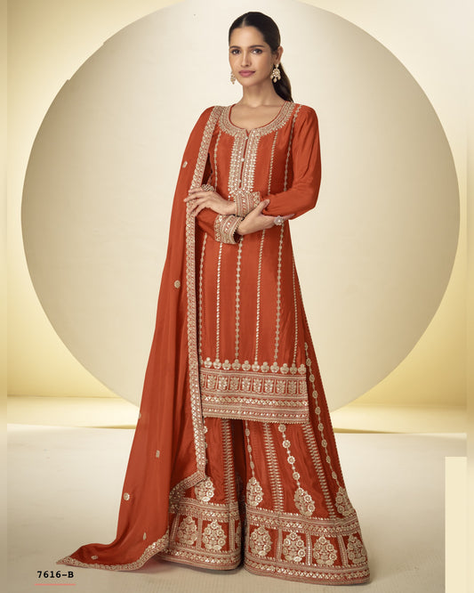 Woman wearing an orange embroidered traditional outfit on a beige background