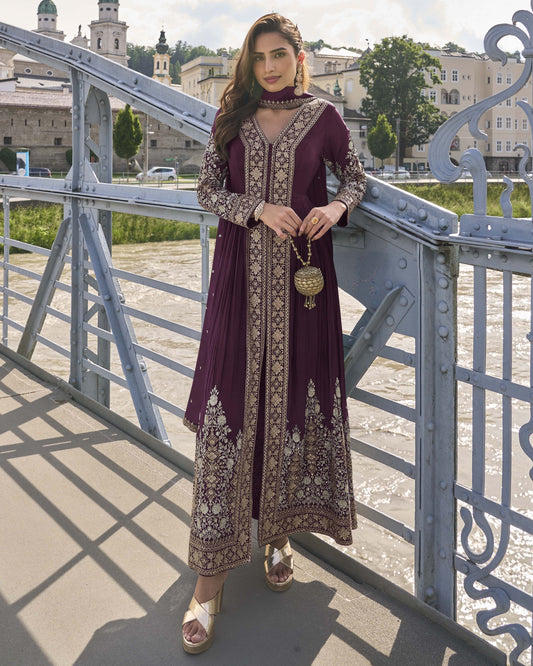 Woman in a purple embroidered dress standing on a bridge with a scenic background