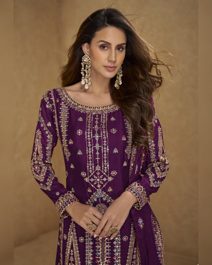 Woman wearing a purple embroidered outfit with gold details against a beige background