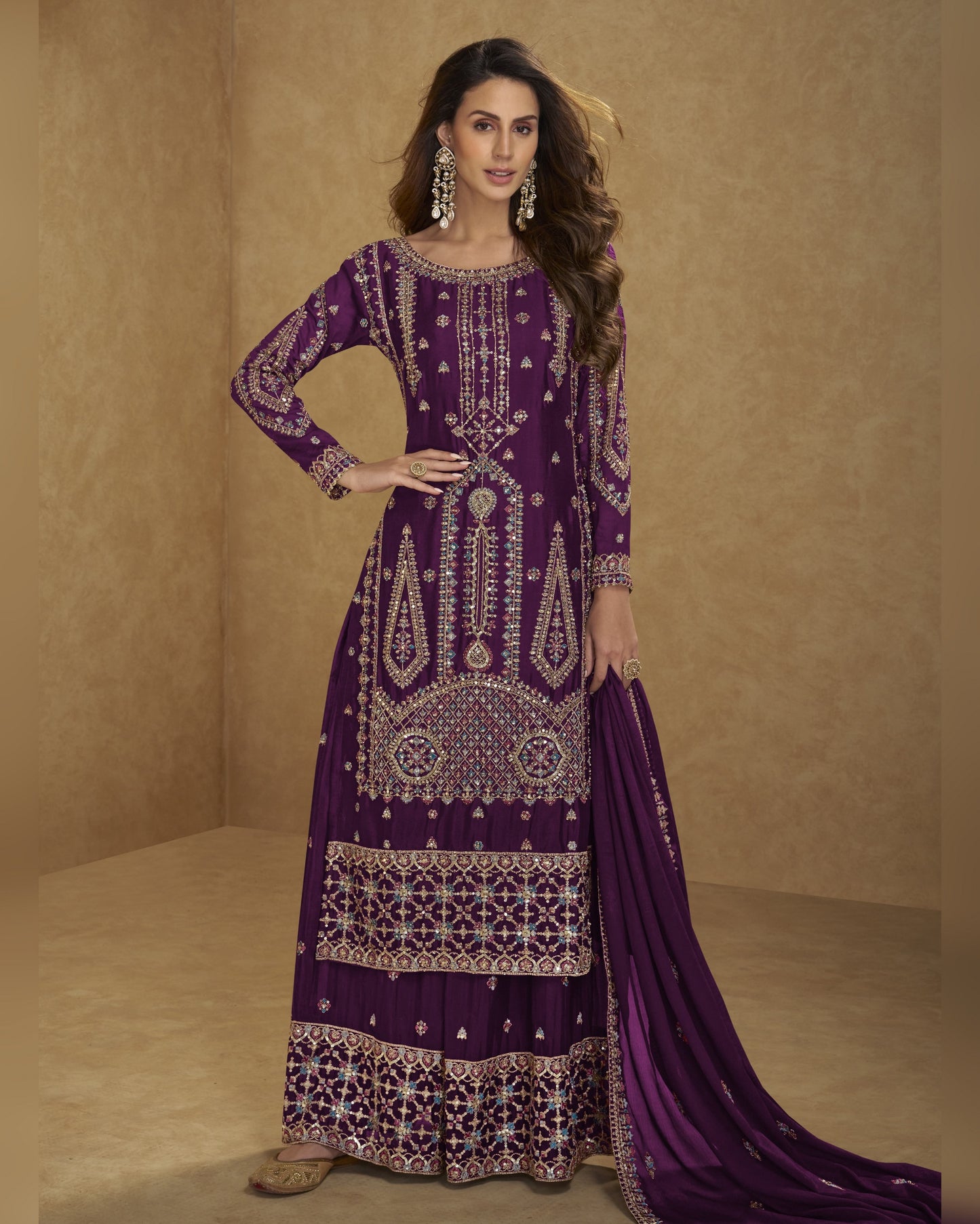 Woman wearing a purple embroidered traditional outfit on a beige background