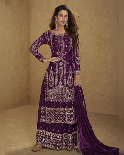 Woman wearing a purple embroidered traditional outfit on a beige background