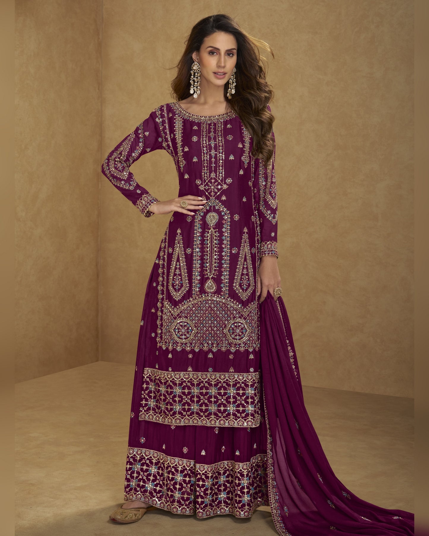Woman wearing a purple embroidered traditional outfit on a beige background