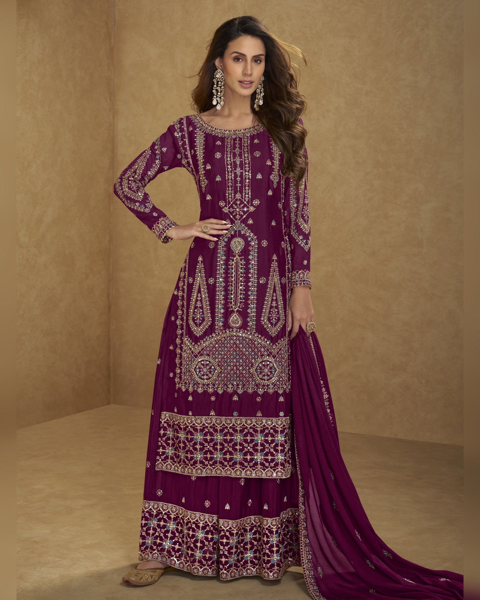 Woman wearing a purple embroidered traditional outfit on a beige background