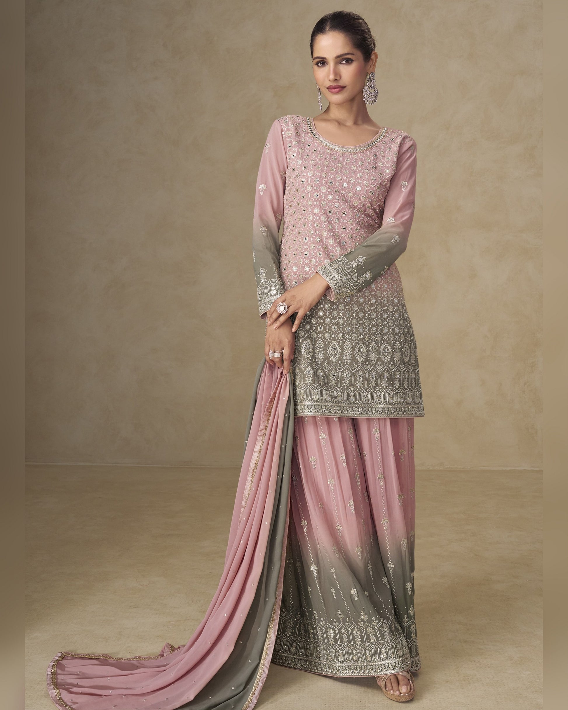 Woman wearing a pink and gray traditional outfit with a plain background