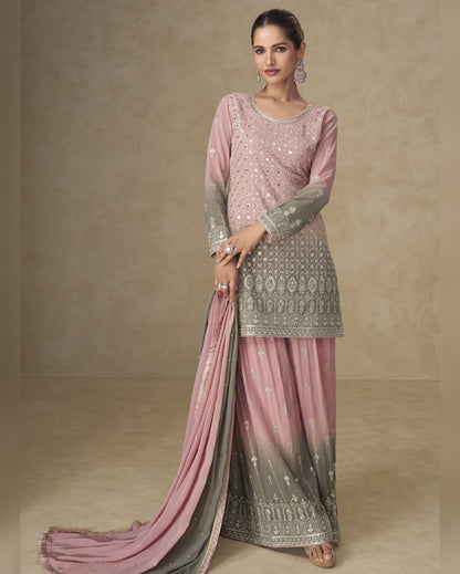 Woman wearing a pink and gray traditional outfit with a plain background