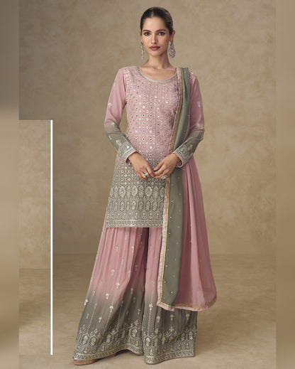 Woman wearing a traditional outfit with pink and gray patterns on a beige background