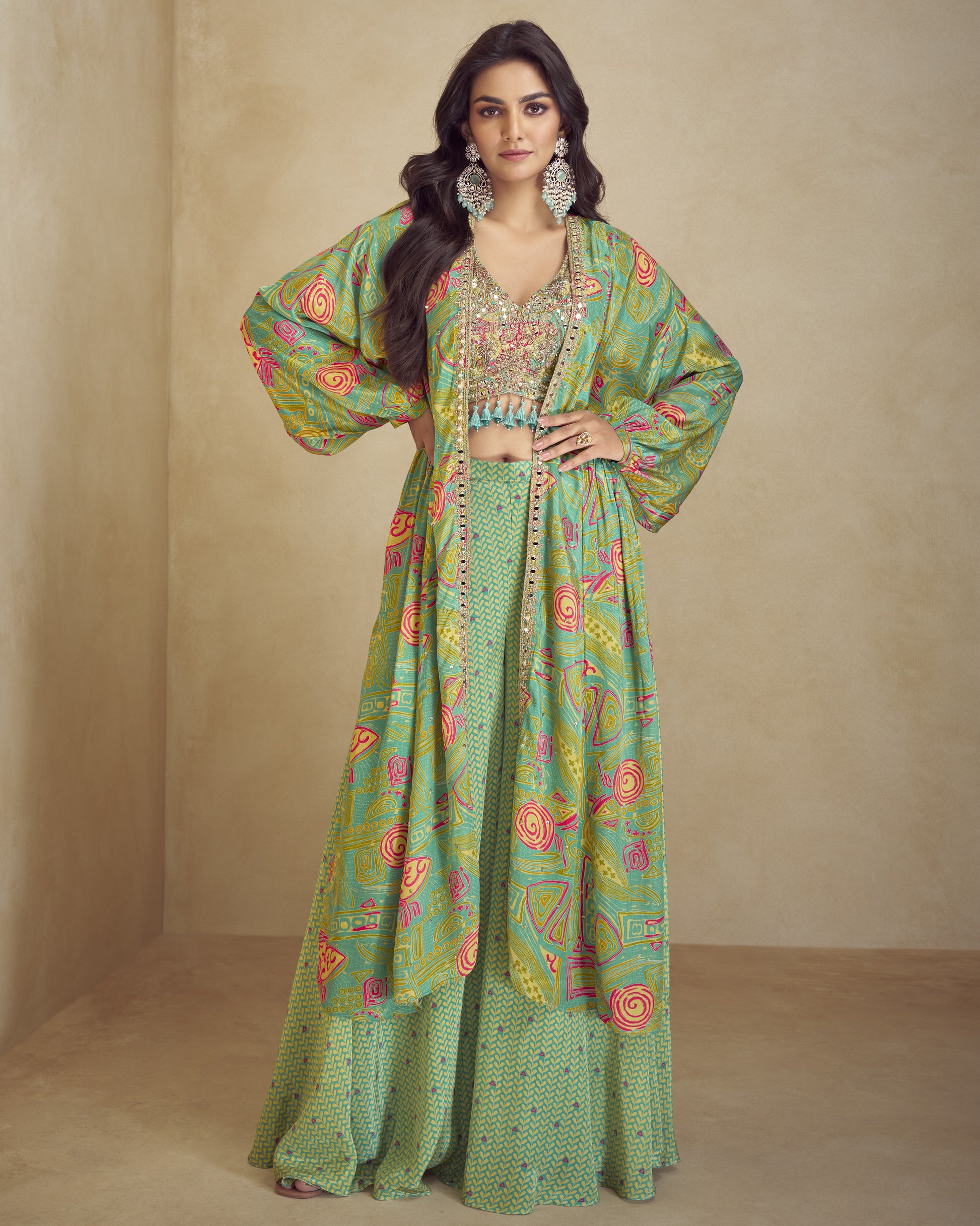 Woman wearing a green patterned outfit with a beige background