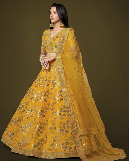 Woman wearing a yellow embroidered traditional outfit with a dark background