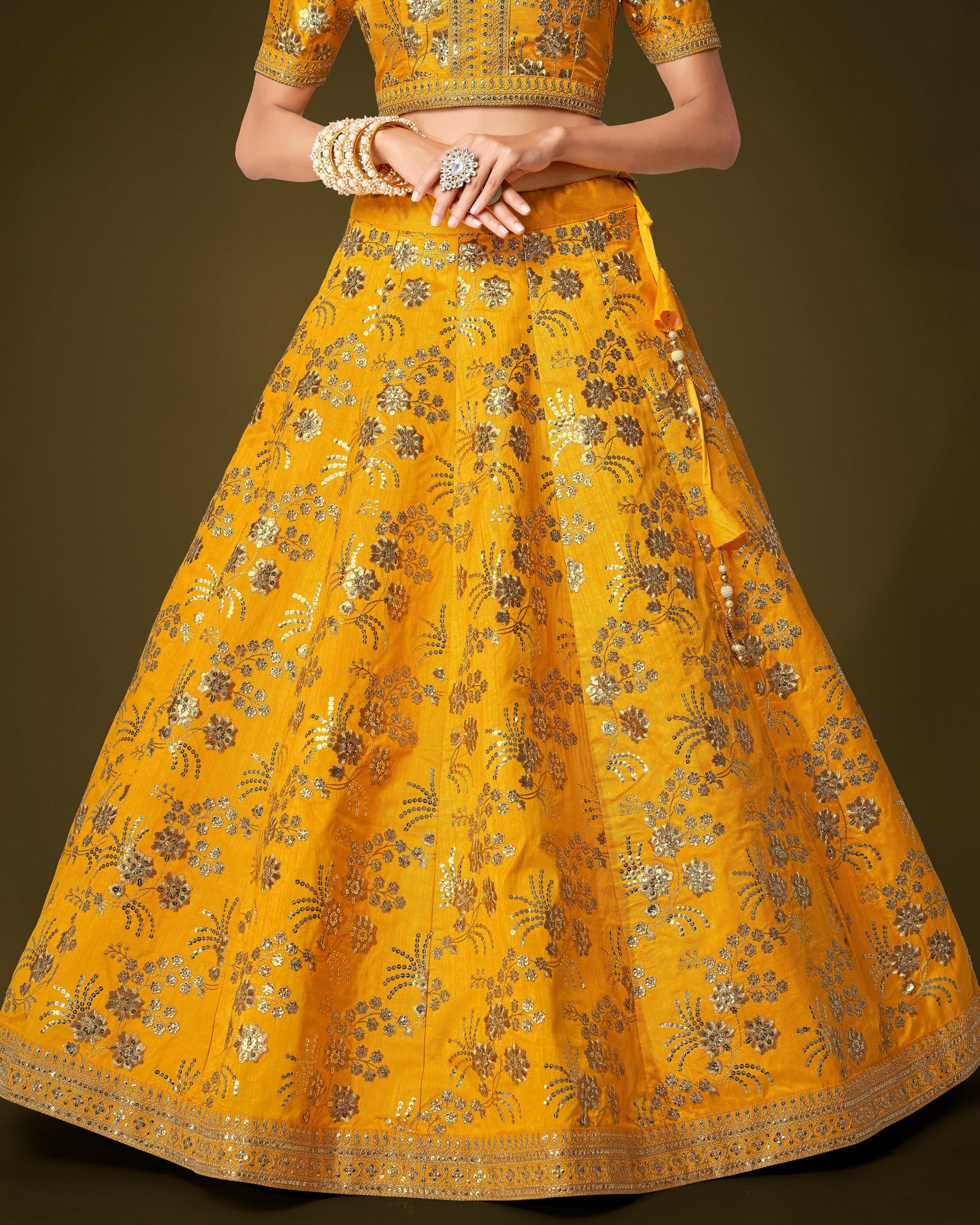 Yellow embroidered traditional outfit on a dark background