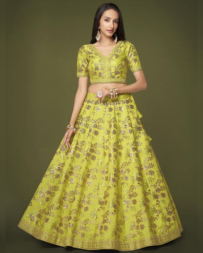 Woman wearing a yellow floral embroidered outfit on a green background