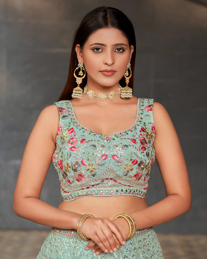 Woman wearing a traditional embroidered blouse with floral patterns against a neutral background