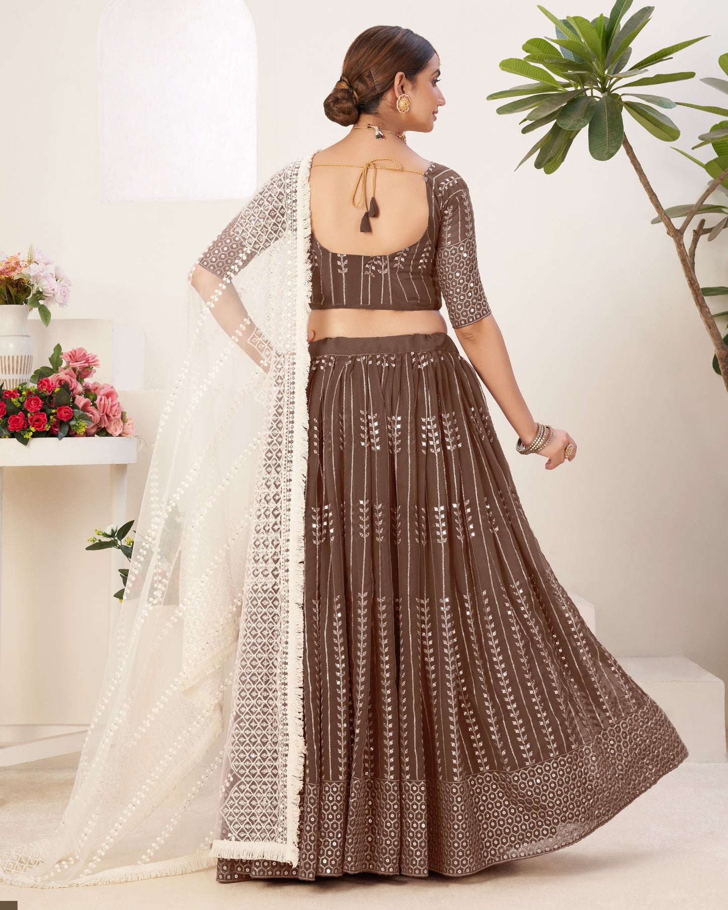 Woman wearing a brown and white traditional outfit with a white background