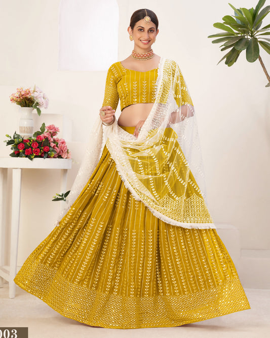 Woman wearing a yellow traditional outfit with a white dupatta against a white background