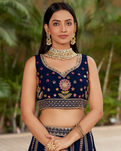 Woman wearing a traditional embroidered blouse with a floral design, standing against a natural background.