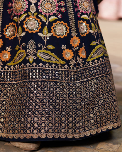 Close-up of a dark blue embroidered garment with floral patterns.