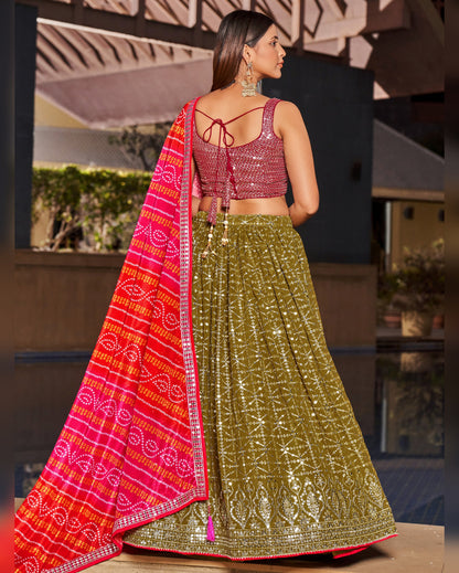 Woman wearing a traditional outfit with a red dupatta and green lehenga in an outdoor setting.