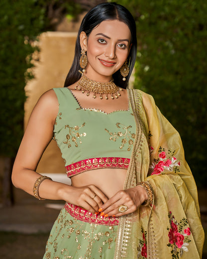 Woman in traditional green and gold outfit with floral details
