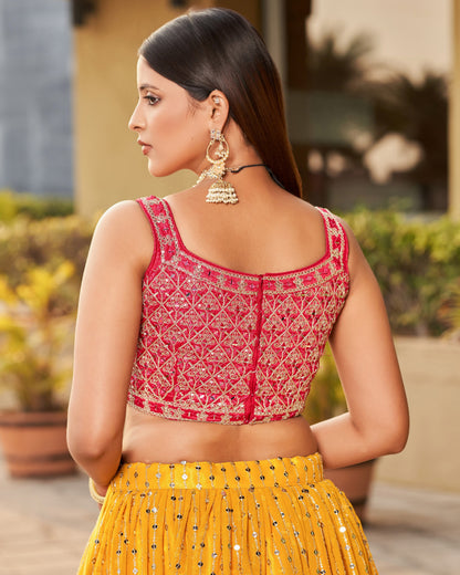 Woman wearing a red and yellow traditional outfit with intricate patterns.