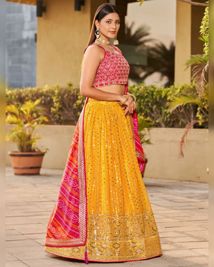 Woman wearing a yellow and pink traditional outfit with a garden background
