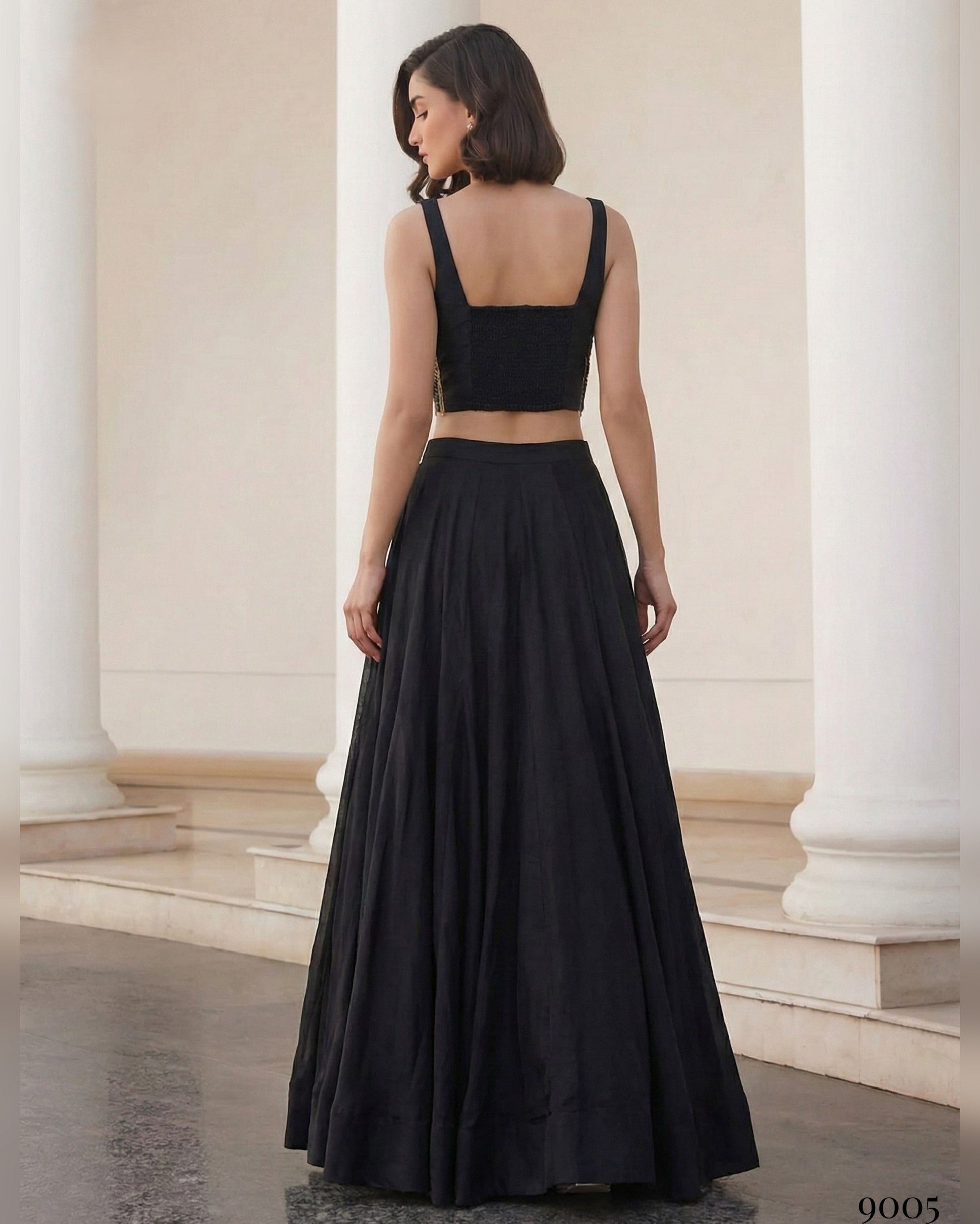 Woman wearing a black dress standing in a classical architectural setting