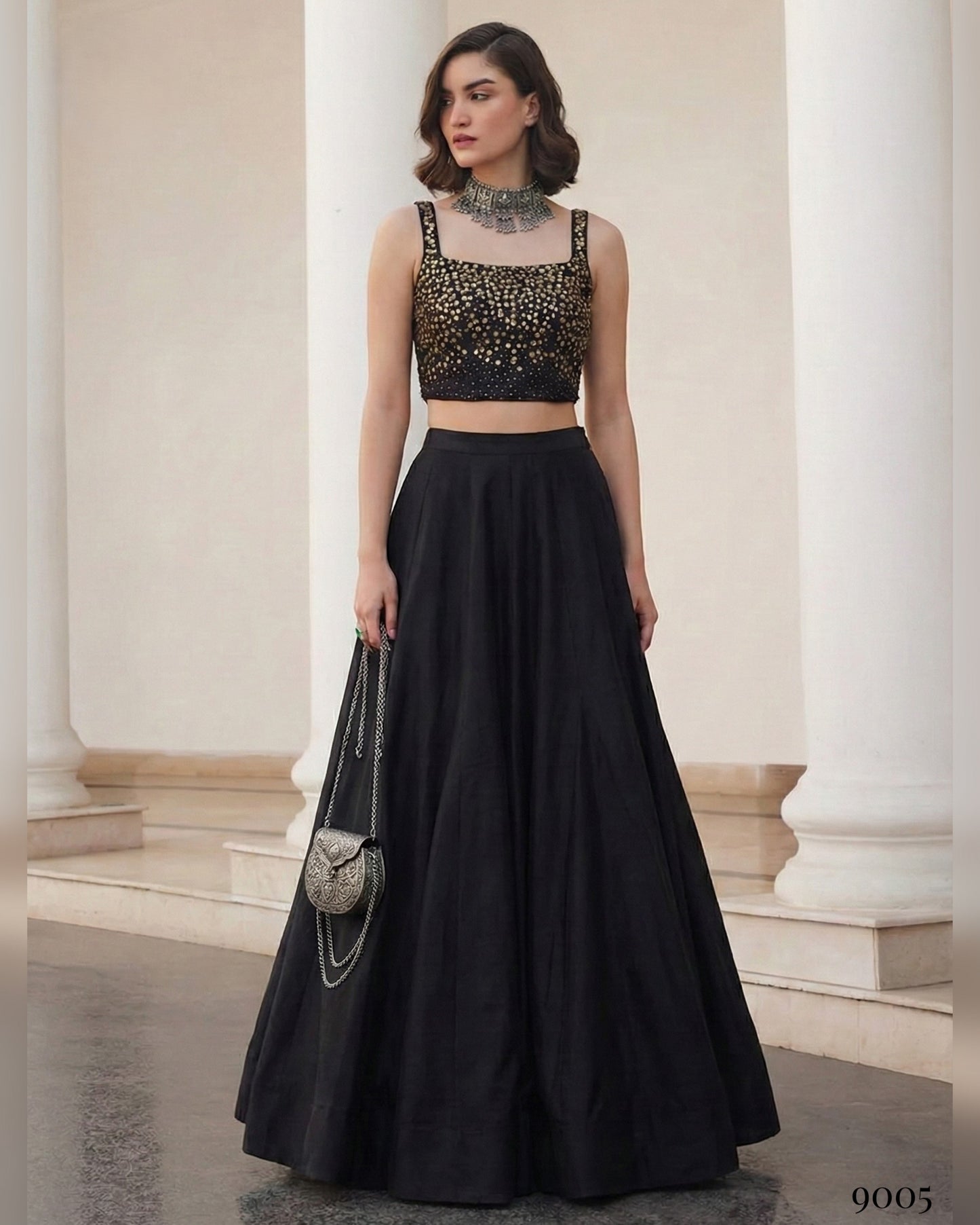 Woman wearing a black outfit with a sparkly top in an elegant setting