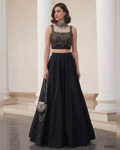 Woman wearing a black outfit with a sparkly top in an elegant setting